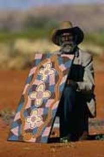 A (genuine) aboriginal dot painter with one of his works